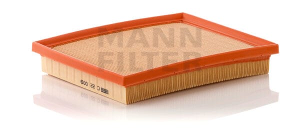 Rectangular air filter with an orange frame and pleated paper element, resting on a white surface.