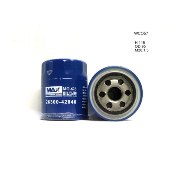 Two blue car oil filters: one upright showing label "MAX MD-628 OIL FILTER 26300-42040," the other lying down displaying the open end. Wall text includes "WC057" and specifications.