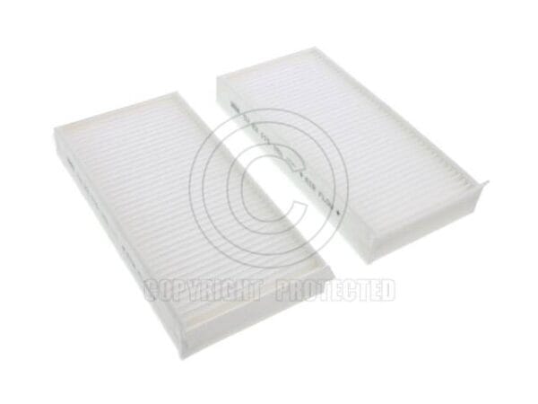 Two rectangular white air filters placed side by side on a plain background.